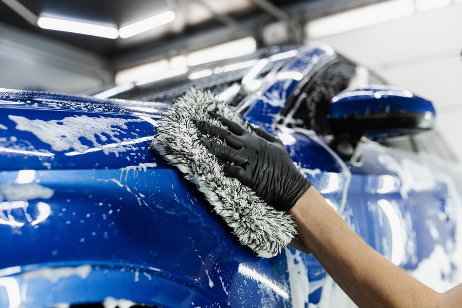 Hand-washing a vehicle exterior with a foam wash mitt