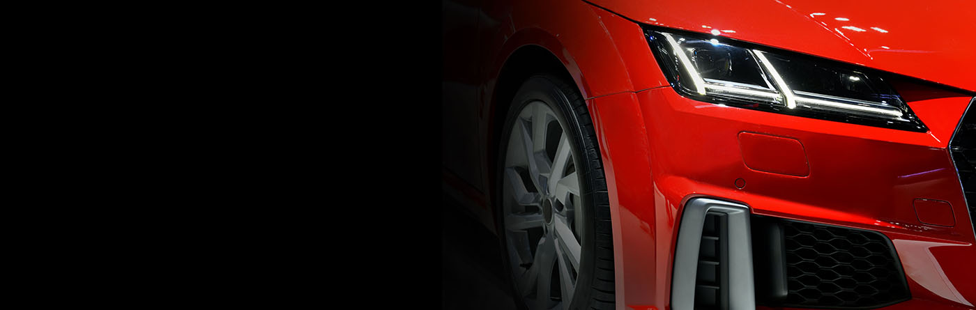 Glossy red sports car with a dramatic, high-shine finish